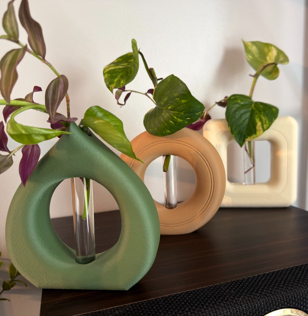 Green, tan, and cream Vine Lab propagation vases with live plant cuttings